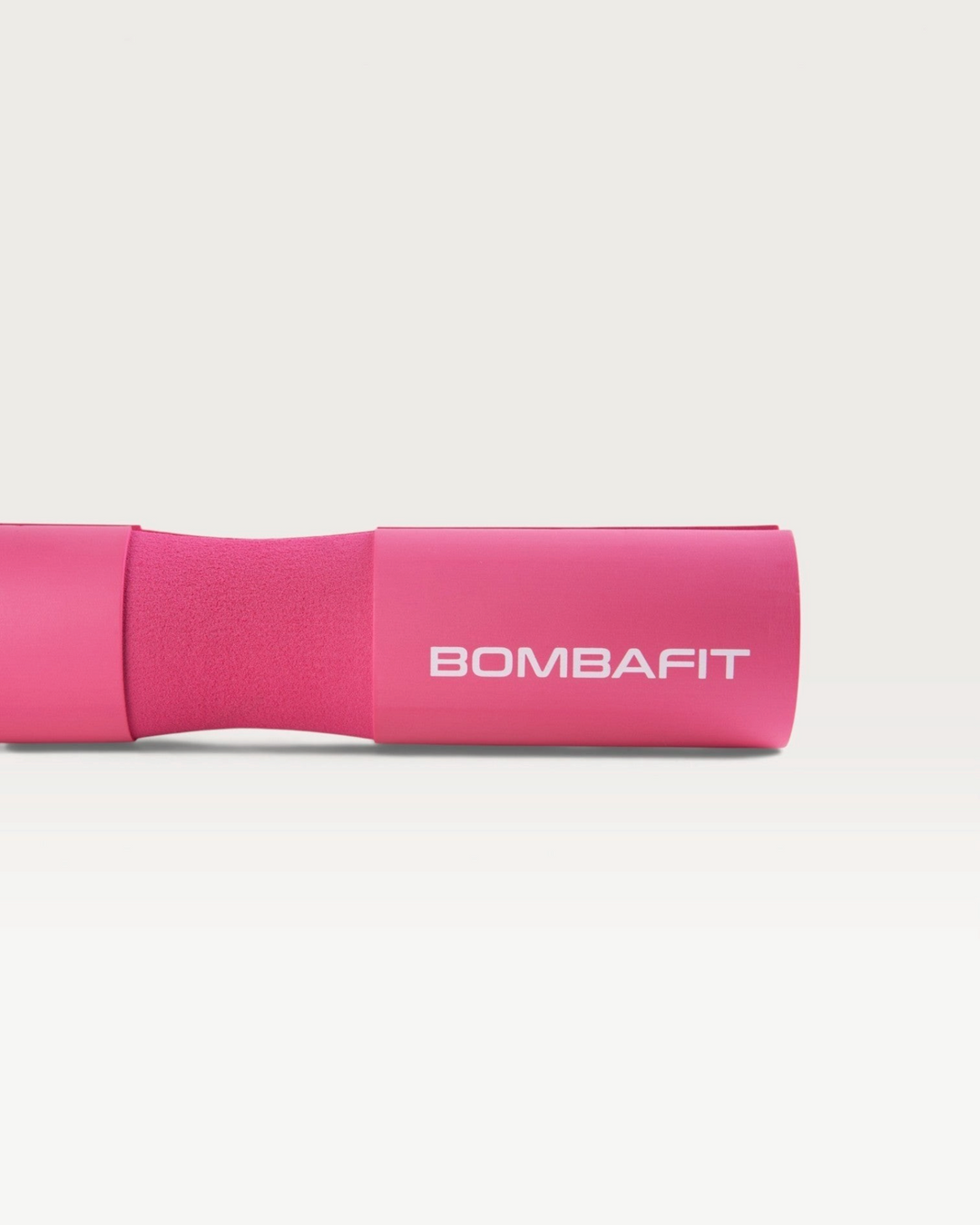 Bilanciere imbottito Bombafit di colore fucsia con logo stampato, ideale per proteggere il collo durante il sollevamento