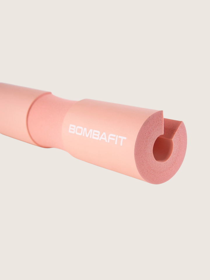 Bilanciere imbottito Bombafit di colore rosa in schiuma protettiva per sollevamento pesi e squat