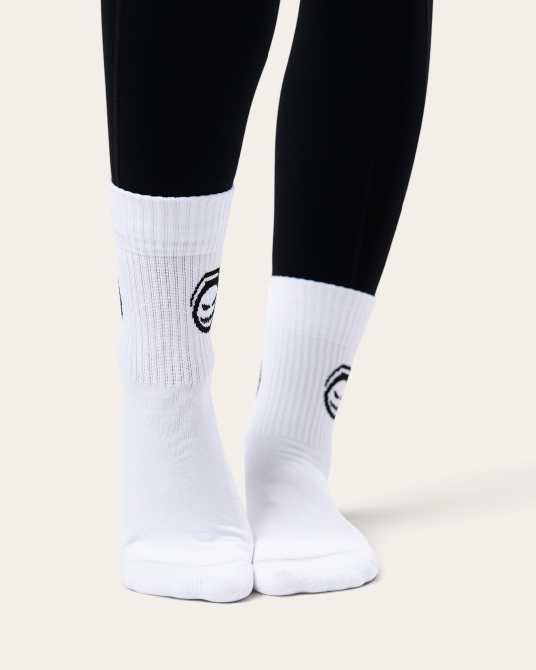 Calzini sportivi bianchi Bombafit con grafica Ectoplasma nera, indossati su leggings neri