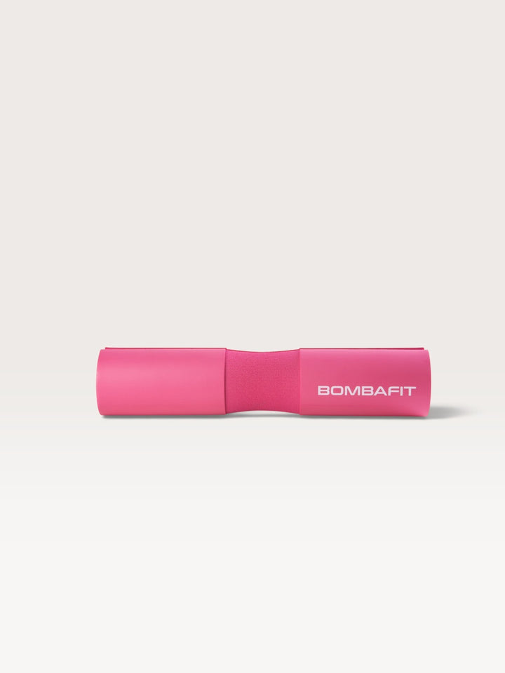 Cuscinetto imbottito per bilanciere Bombafit di colore fucsia per sollevamento pesi e squat