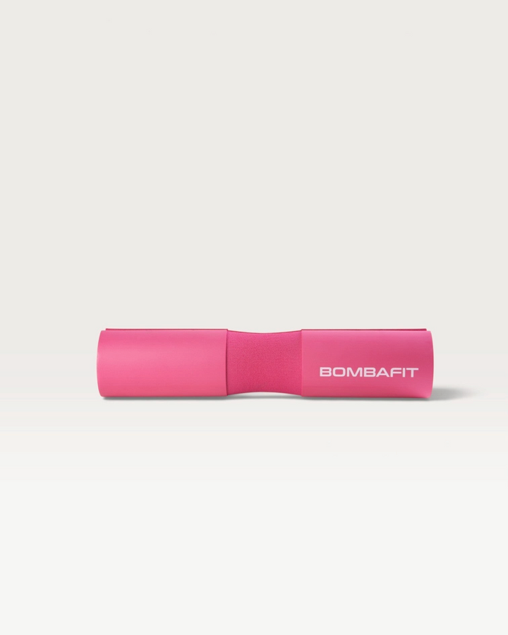 Cuscinetto imbottito per bilanciere Bombafit di colore fucsia per sollevamento pesi e squat