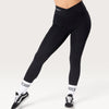 Leggings neri Bombafit a vita alta con incrocio frontale, tasche laterali e vestibilità compressiva per fitness