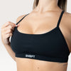 Top sportivo nero Bombafit con spalline sottili, banda elastica sotto il seno e tessuto traspirante seamless